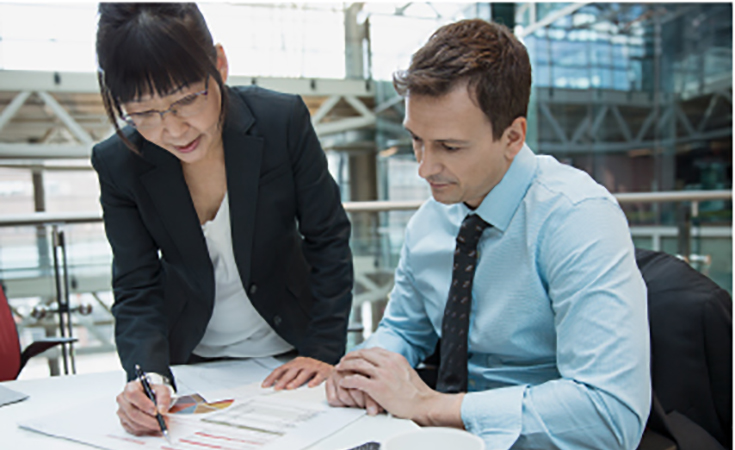 Three people looking at a file