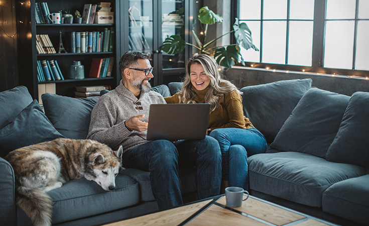 Couple on couch with laptop